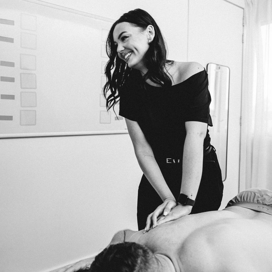 Physiotherapist treating a patient's upper back at Elevate Health